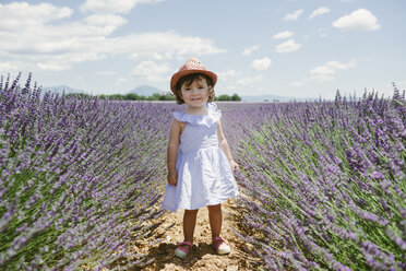 France, Provence, Valensole plateau, Happy toddler girl standing in purple lavender fields in the summer - GEMF02130