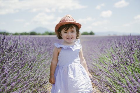 France, Provence, Valensole plateau, Happy toddler girl in purple lavender fields in the summer stock photo