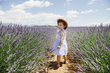 France, Provence, Valensole plateau, Happy toddler girl standing in purple lavender fields in the summer - GEMF02142