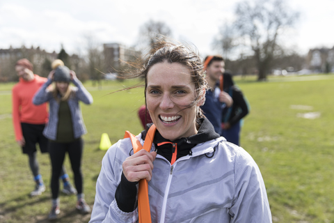 Portrait smiling, confident woman exercising in park stock photo