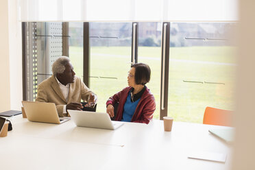 Senior business people talking in conference room meeting - CAIF21280