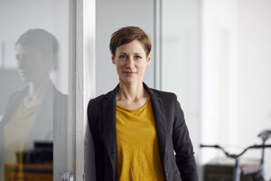 Businesswoman with bicycle in her start-up company - RBF06454