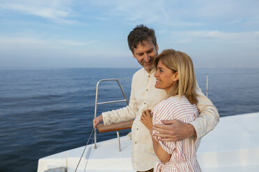 Mature couple enjoying quality time on sailing trip on a catamaran - EBSF02618