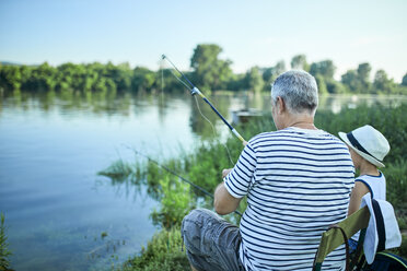 Senior man fishing, relaxing at a tree stock photo