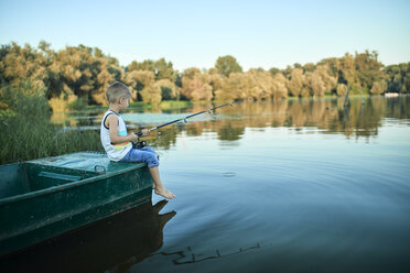 Little boy with fishing rod sitting on boat - ZEDF01493