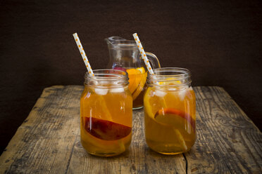 Two glasses of peach orange ice tea on wood - LVF07307