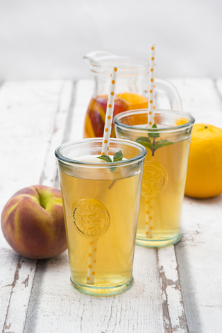 Two glasses of peach orange ice tea stock photo