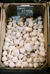 A wooden crate of garlic bulbs. - MINF00258