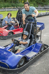 Boys and men go-karting on a track. - MINF00356