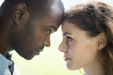 A young man and woman, a couple. Touching foreheads, viewed in profile. - MINF00378