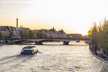 France, Paris, Pont du Carrousel with tourist boat at sunset - WDF04714