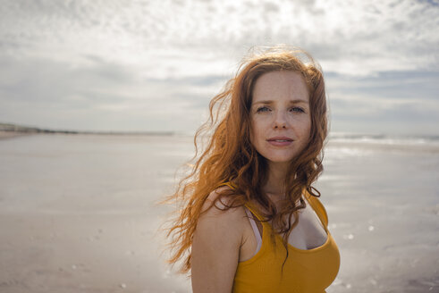 Netherlands, Zeeland, portrait of redheaded woman on the beach - KNSF04190