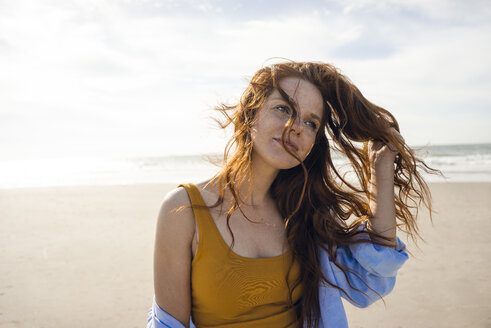 Netherlands, Zeeland, portrait of redheaded woman on the beach - KNSF04202