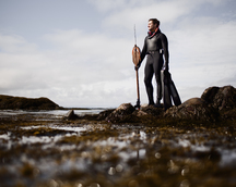 Man with a Spear Standing in the Sea · Free Stock Photo