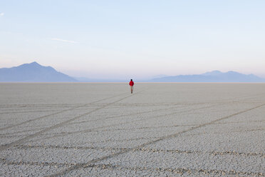 A man in the flat playa, salt pan, of Black Rock Desert, Nevada. - MINF00500