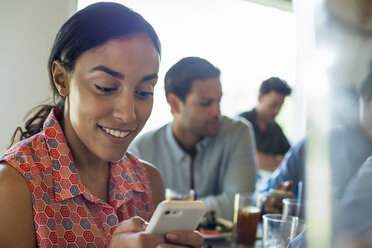 A group of men and women in a cafe, having drinks and enjoying each other's company. - MINF00615