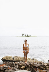 A young woman on the shore on a cloudy day in Las Galeras, Samana Peninsula, Dominican Republic. - MINF00708