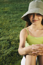 Portrait of smiling nine year old girl, field of grass in background - MINF00784