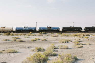 A goods train on the train track running through the desert. Freight wagons. - MINF00787