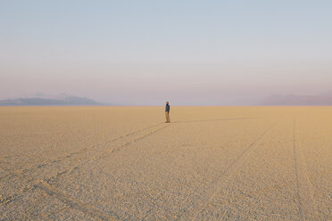 The figure of a man in the empty desert landscape of Black Rock desert, Nevada. - MINF00794