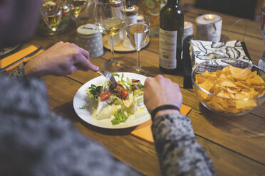 Man eating at dinner with friends - AWF00105