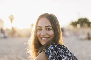 Beautiful woman on the beach at sunset, portrait - AFVF00828