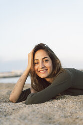 Beautiful woman relaxing on the beach at sunset, portrait - AFVF00835