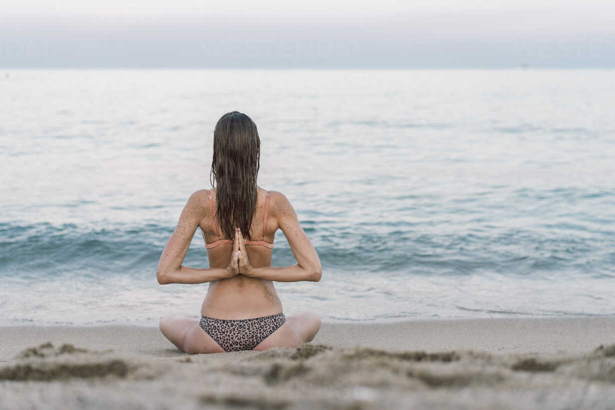 https://us.images.westend61.de/0001007240pw/beautiful-woman-on-the-beach-practicing-yoga-AFVF00845.jpg
