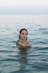 Beautiful woman at the beach, swimming in the sea - AFVF00848