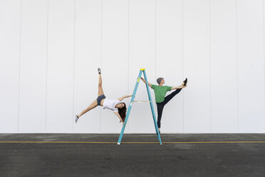 Two acrobats doing tricks on a ladder - AFVF00895