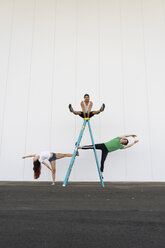 Three acrobats doing tricks on a ladder - AFVF00898