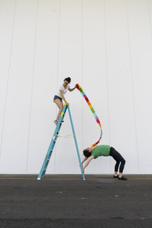 Two acrobats exercising trick on a ladder with a ribbon - AFVF00900