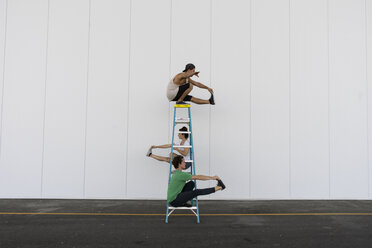 Three acrobats doing tricks on a ladder - AFVF00903