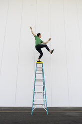 Acrobat balancing on ladder - AFVF00906