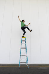 A Man Balancing on a Ladder · Free Stock Photo