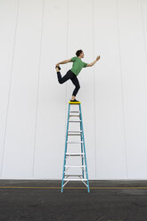 Acrobat balancing on ladder - AFVF00907