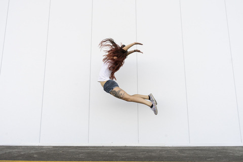 Young acrobat jumping in air stock photo