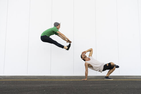 Two acrobats doing tricks together, jumping mid-air - AFVF00925