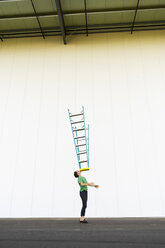 Acrobat balancing ladder on his face - AFVF00930