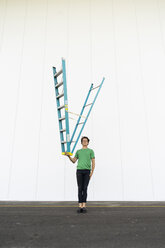Acrobat balancing ladder upside down in his hand - AFVF00934