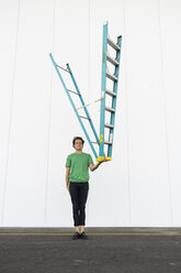 Acrobat balancing ladder upside down in his hand - AFVF00936