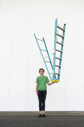 Acrobat balancing ladder upside down in his hand - AFVF00937