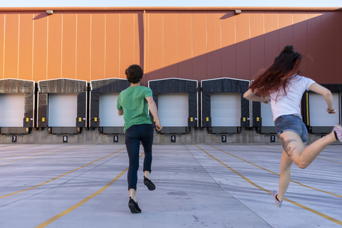 Two acrobats running during training, rear view stock photo