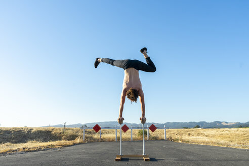 Acrobat doing handstand on handstand canes - AFVF00952