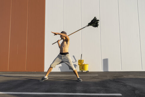 Acrobat playing with cleaning bucket and mop - AFVF00986