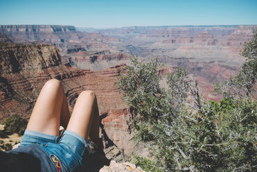 USA, Arizona, Grand Canyon National Park, legs of tourist relaxing at Grand Canyon - GEMF02188