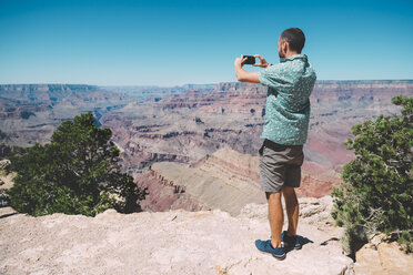 USA, Arizona, Grand Canyon National Park, Grand Canyon, Mann macht Fotos mit Smartphone - GEMF02192