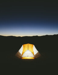 Beleuchtetes Campingzelt in der weiten Wüste in der Abenddämmerung, Black Rock Desert, Nevada - MINF01129