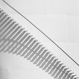 Steps leading up the side of a white storage tank at an oil refinery plant. A pattern of shadows. - MINF01202
