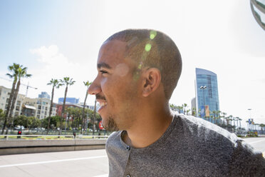 Portrait of a smiling young man standing in a street. - MINF01351